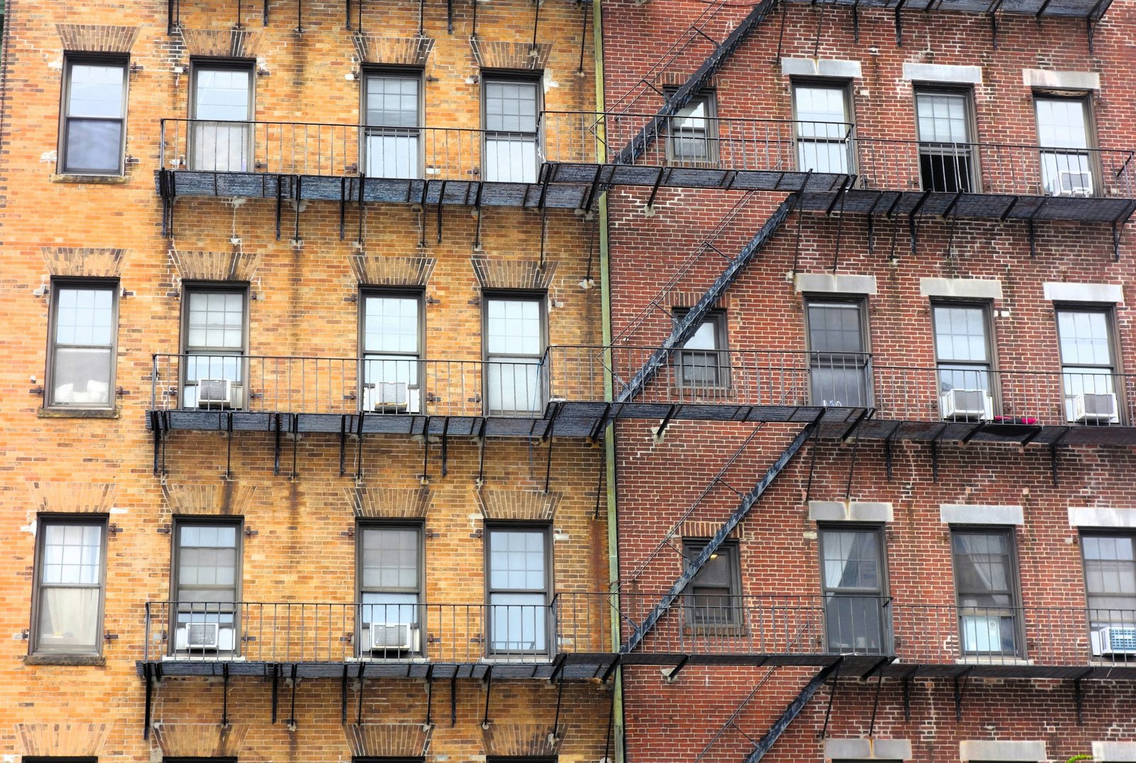 Brick apartment buildings with fire escapes, representing the off-market multifamily deals shared with our cash buyer list