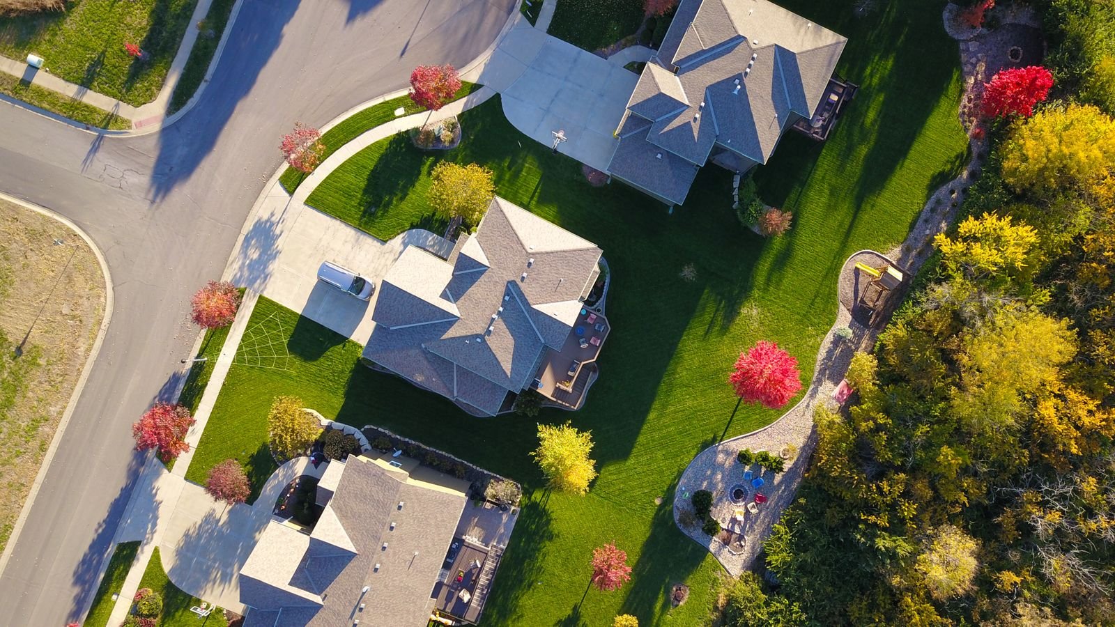 Aerial view of a Midwestern residential neighborhood with single-family homes and tree-lined streets in autumn